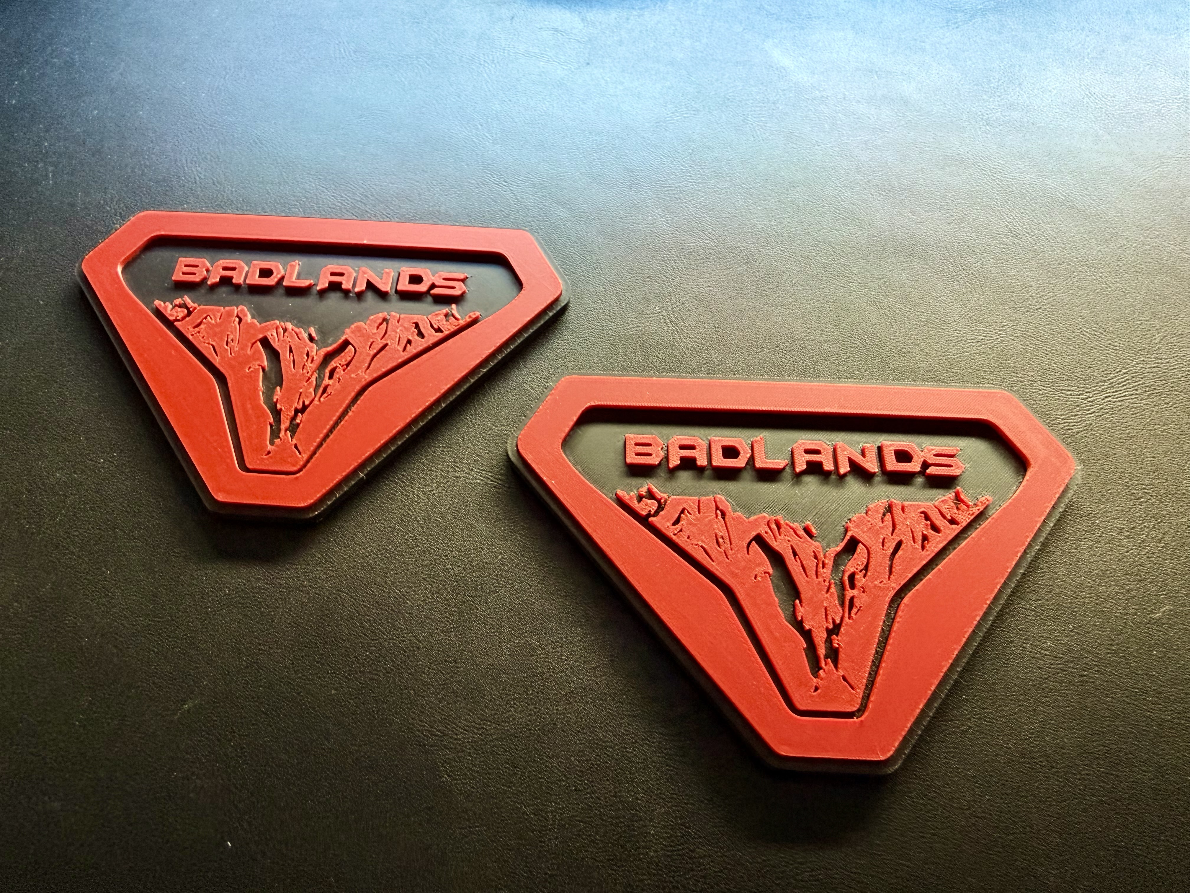 Pair of red and black Bronco-compatible custom 3D printed badges